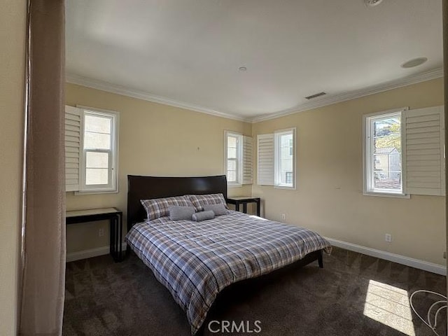 bedroom featuring dark colored carpet, multiple windows, and crown molding