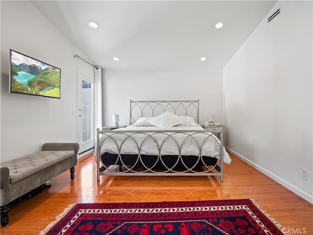 bedroom featuring visible vents, access to outside, wood finished floors, recessed lighting, and baseboards