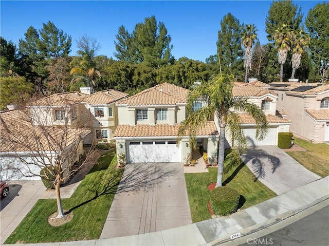 mediterranean / spanish-style house featuring a front lawn, a tiled roof, driveway, and stucco siding