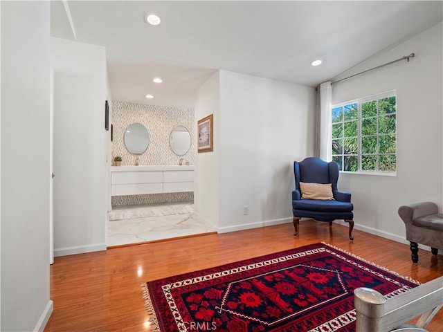 living area featuring recessed lighting, baseboards, lofted ceiling, and wood finished floors