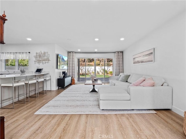 living room featuring recessed lighting, wood finished floors, and baseboards