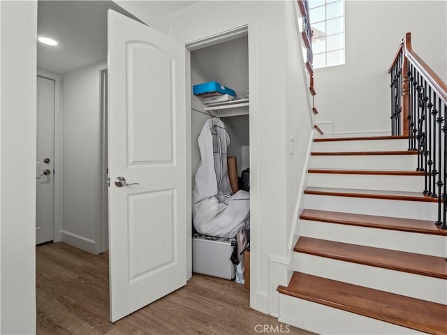 stairs featuring wood finished floors