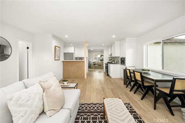 living room with recessed lighting and light wood finished floors