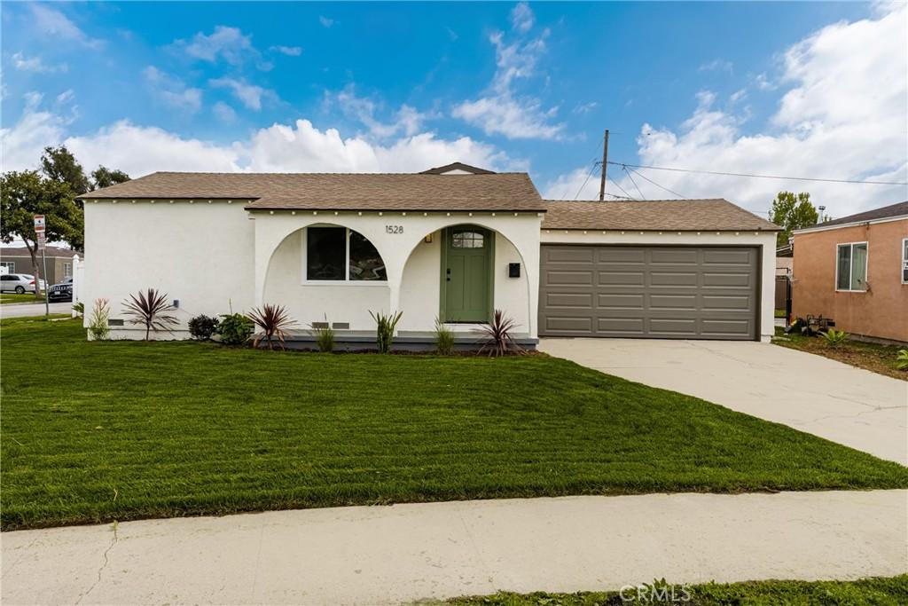 1528 E 126th St, Compton, CA 90222 - ranch-style home featuring concrete driveway, stucco siding, a front lawn, and a garage