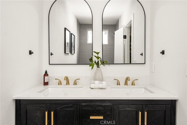 bathroom featuring a sink and double vanity