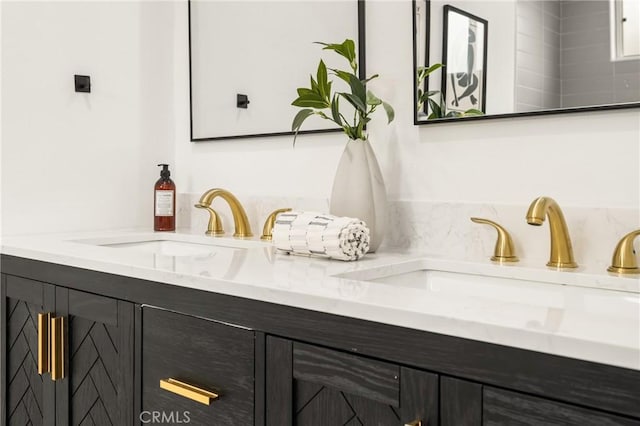 bathroom featuring a sink and double vanity