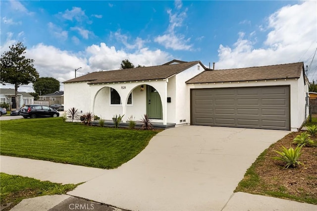 view of front of home featuring stucco siding, an attached garage, concrete driveway, and a front lawn