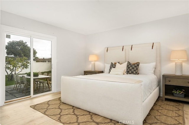 bedroom featuring wood finished floors and access to outside