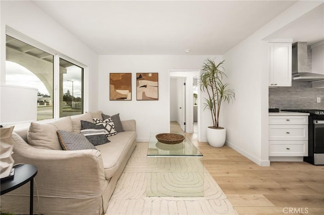 living room featuring baseboards and light wood-style floors