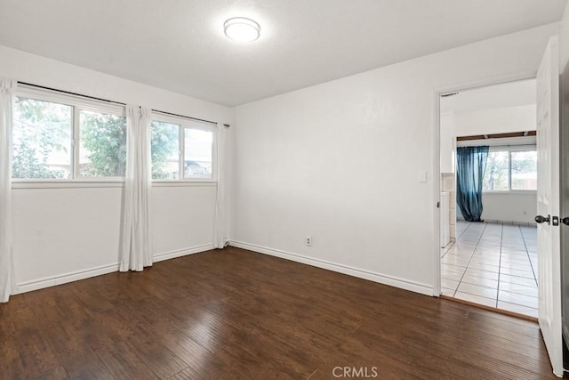 empty room featuring baseboards and wood finished floors