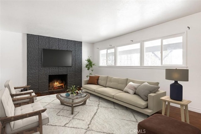 living room featuring wood finished floors, a fireplace, and baseboards