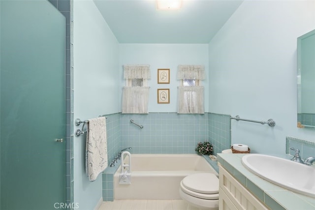 bathroom featuring a bath, tile patterned floors, toilet, and vanity