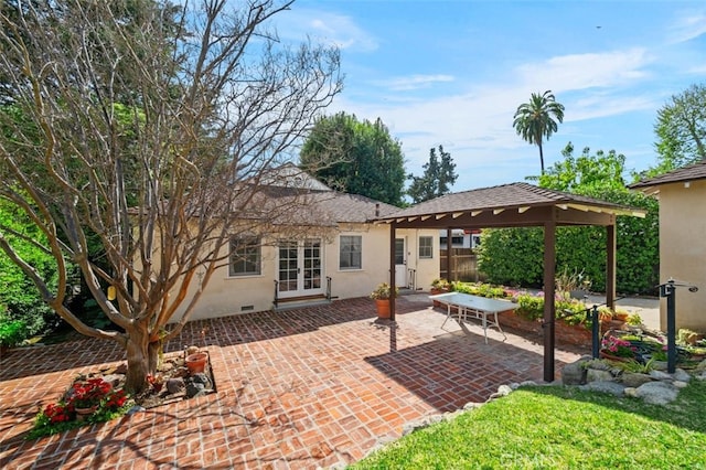 back of house with stucco siding, french doors, a shingled roof, crawl space, and a patio area