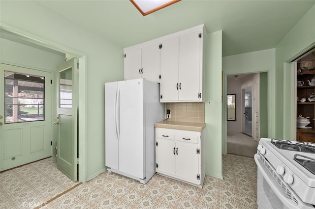 kitchen with tile countertops, decorative backsplash, white appliances, and white cabinetry