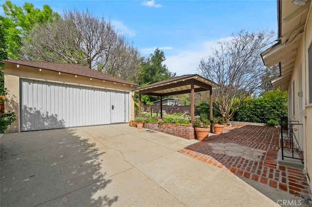 view of patio with an outbuilding and fence