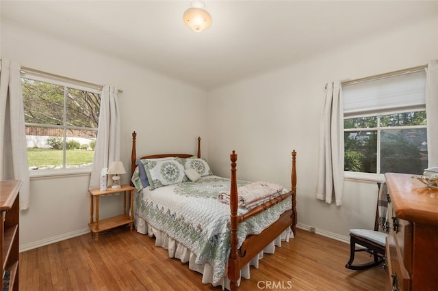 bedroom with baseboards and wood finished floors