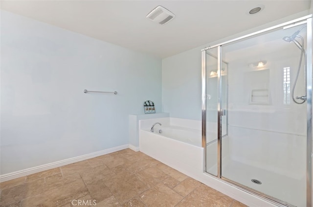 bathroom with baseboards, visible vents, a shower stall, stone finish floor, and a bath