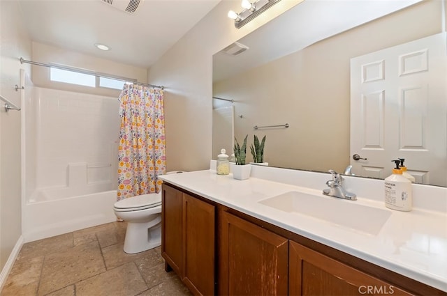 full bath with visible vents, toilet, shower / tub combo with curtain, stone tile floors, and vanity