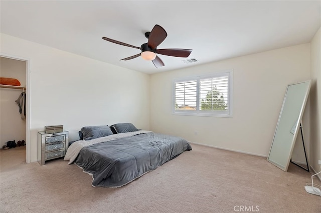 bedroom with visible vents, ceiling fan, a spacious closet, a closet, and carpet flooring