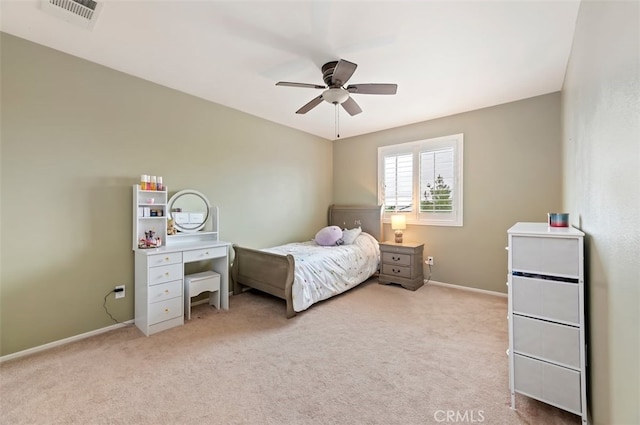 bedroom featuring ceiling fan, light colored carpet, visible vents, and baseboards