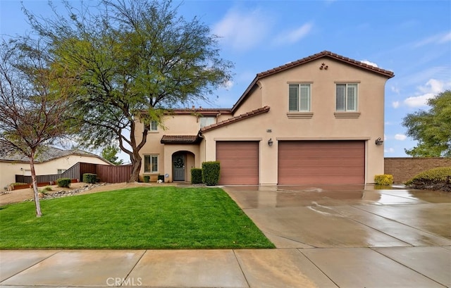 mediterranean / spanish-style home featuring stucco siding, a tiled roof, concrete driveway, and fence