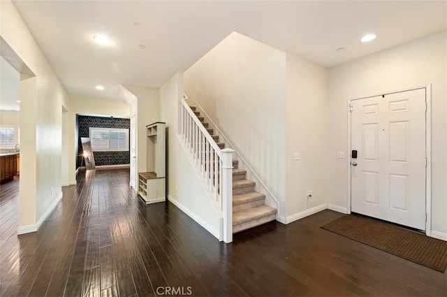 entrance foyer featuring recessed lighting, stairway, baseboards, and dark wood-type flooring