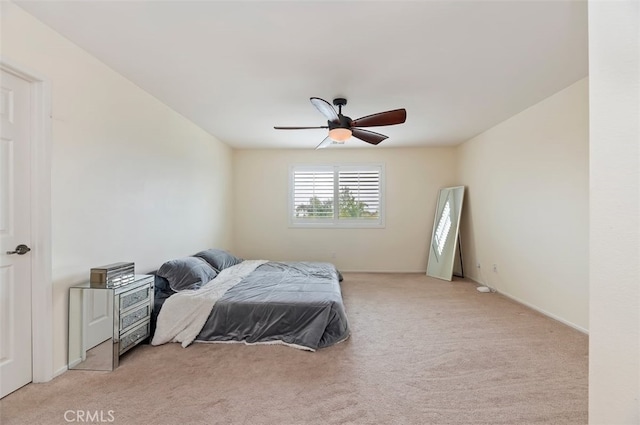 bedroom featuring a ceiling fan and light colored carpet