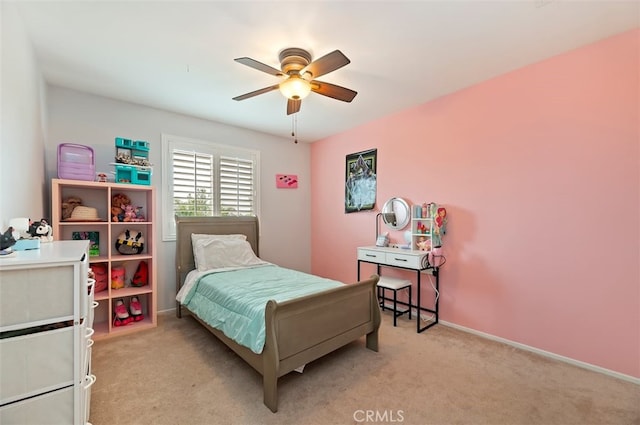 bedroom featuring a ceiling fan, light colored carpet, and baseboards