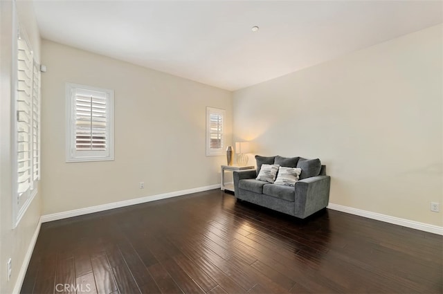 sitting room with baseboards and wood finished floors