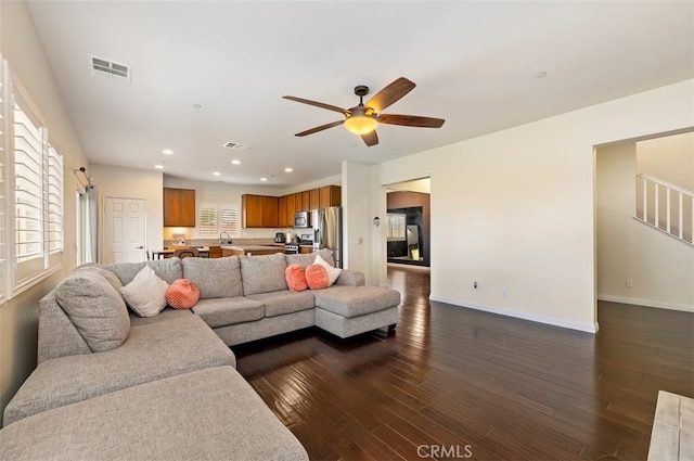 living area featuring visible vents, baseboards, ceiling fan, recessed lighting, and dark wood-style flooring