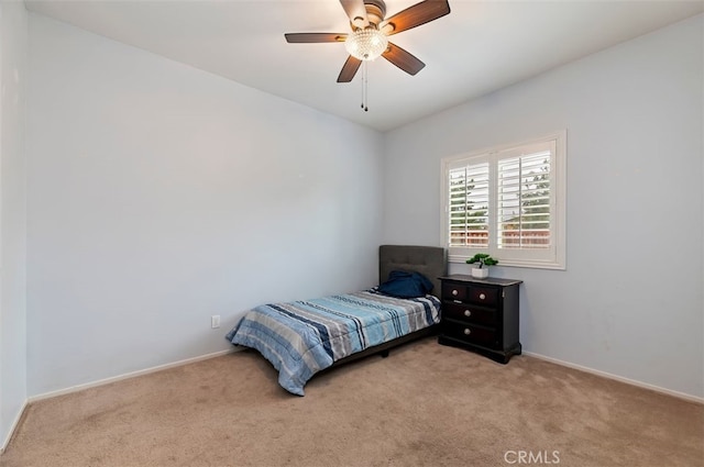 bedroom with a ceiling fan and light carpet