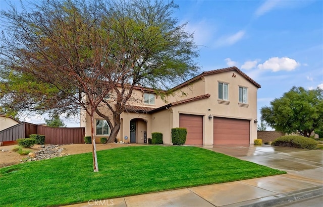 mediterranean / spanish-style home featuring fence, a tiled roof, stucco siding, a garage, and driveway