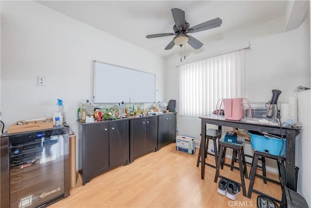 interior space with wine cooler, wood finished floors, and a ceiling fan