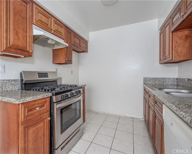 kitchen with stainless steel gas range oven, under cabinet range hood, dishwasher, brown cabinetry, and a sink