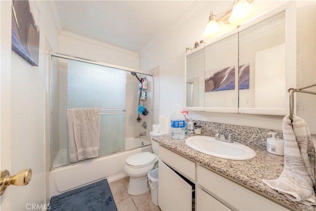 bathroom with toilet, crown molding, tile patterned flooring, enclosed tub / shower combo, and vanity