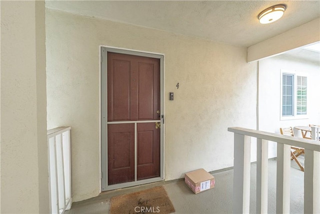 property entrance with stucco siding