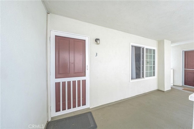 property entrance with stucco siding