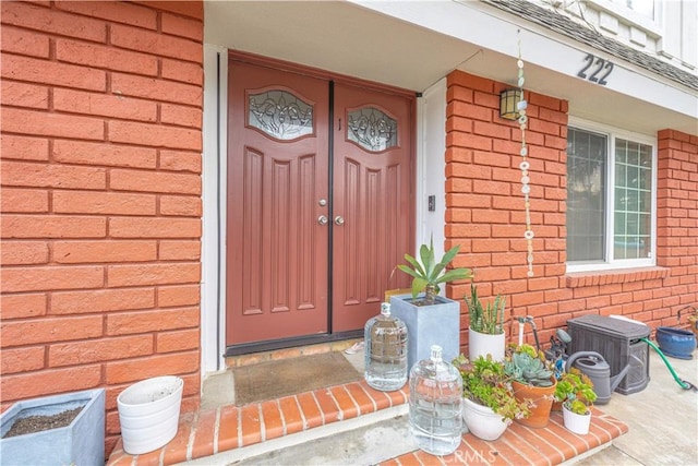 property entrance featuring brick siding