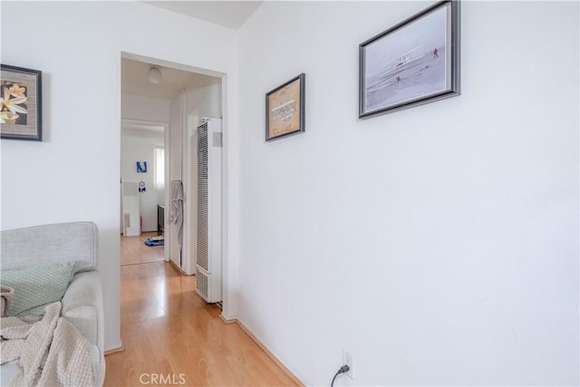 corridor featuring light wood finished floors