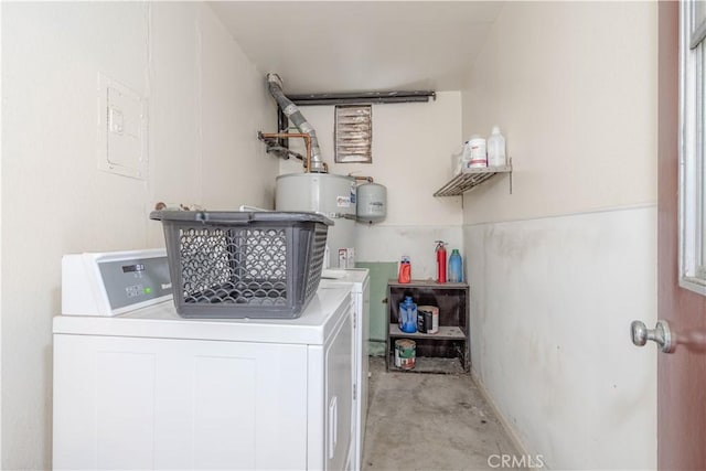 clothes washing area featuring water heater, laundry area, and independent washer and dryer