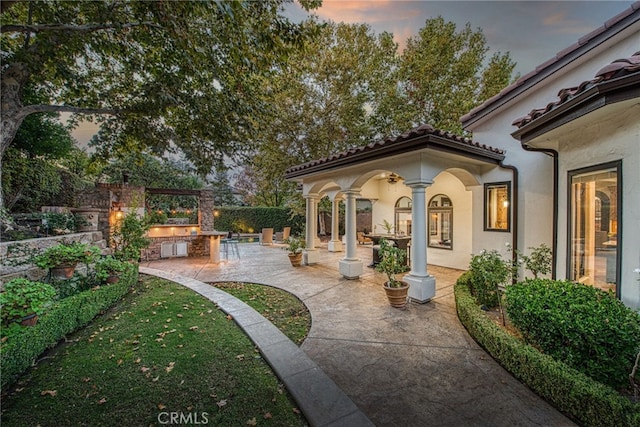 view of patio with fence and an outdoor kitchen