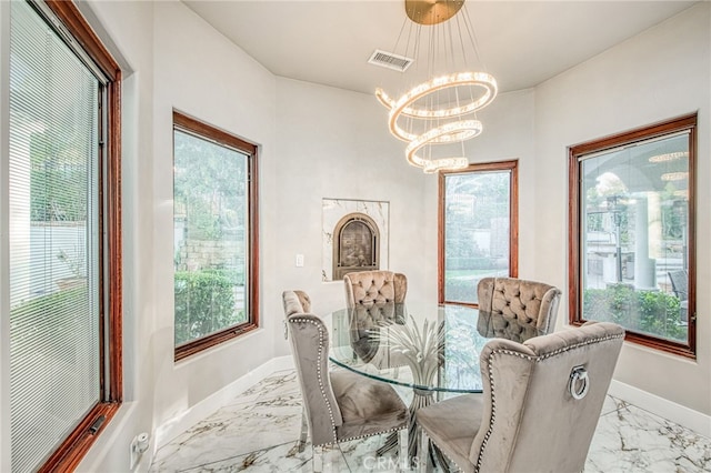 dining space with visible vents, marble finish floor, baseboards, and an inviting chandelier