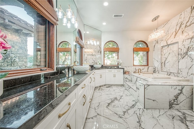 full bath with visible vents, recessed lighting, a bath, marble finish floor, and vanity