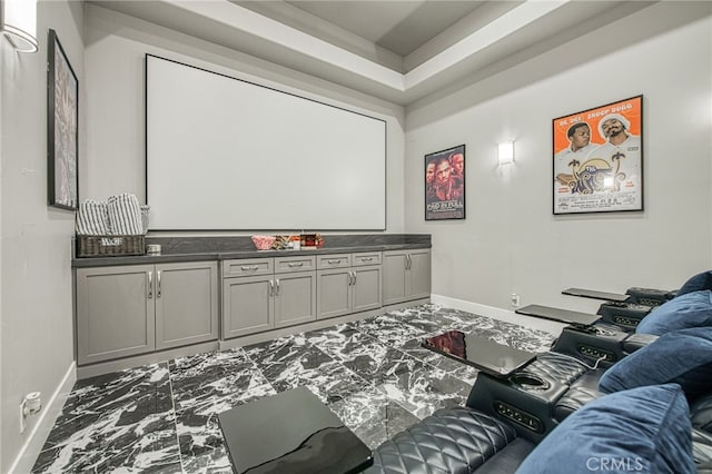 cinema room featuring baseboards and marble finish floor