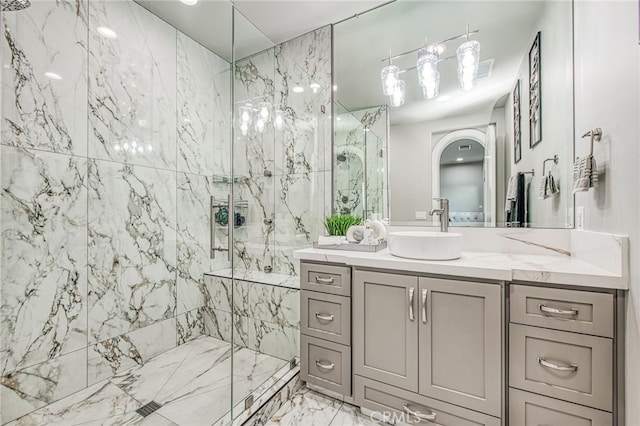 bathroom featuring vanity, marble finish floor, and a marble finish shower