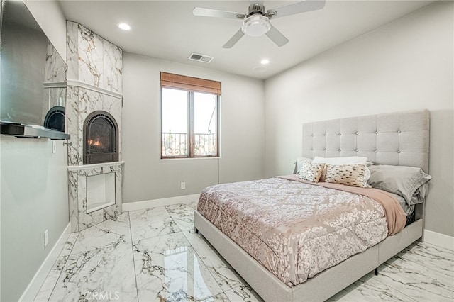 bedroom with recessed lighting, visible vents, baseboards, and a warm lit fireplace