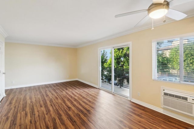 empty room with ornamental molding, wood finished floors, a wall unit AC, baseboards, and ceiling fan