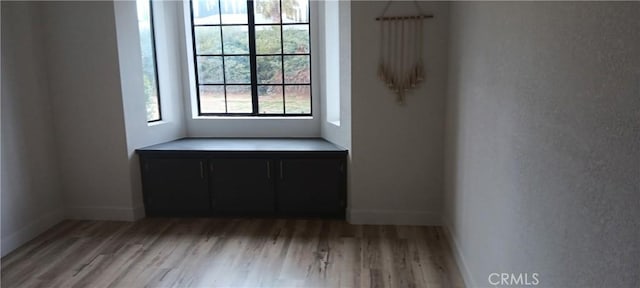 empty room with light wood-type flooring and baseboards