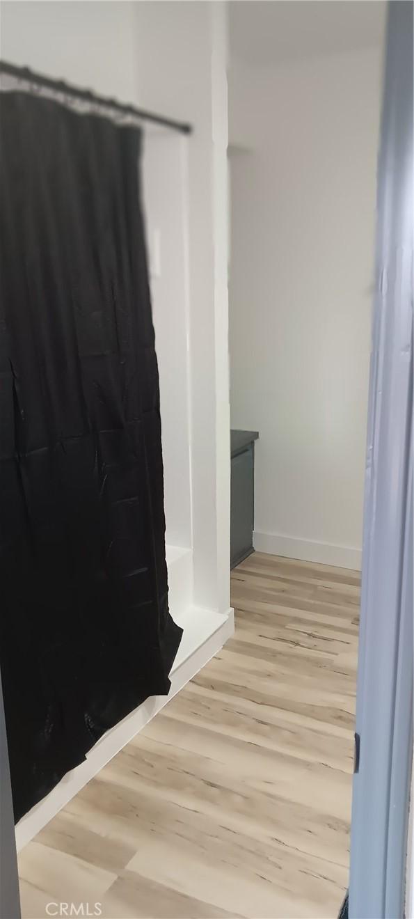 bathroom featuring baseboards and wood finished floors