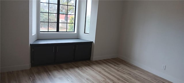 empty room with light wood finished floors and baseboards